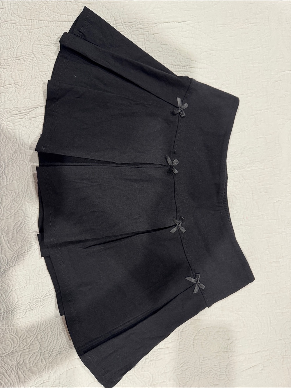 Black Pleated Mini Skirt with Bow Accents